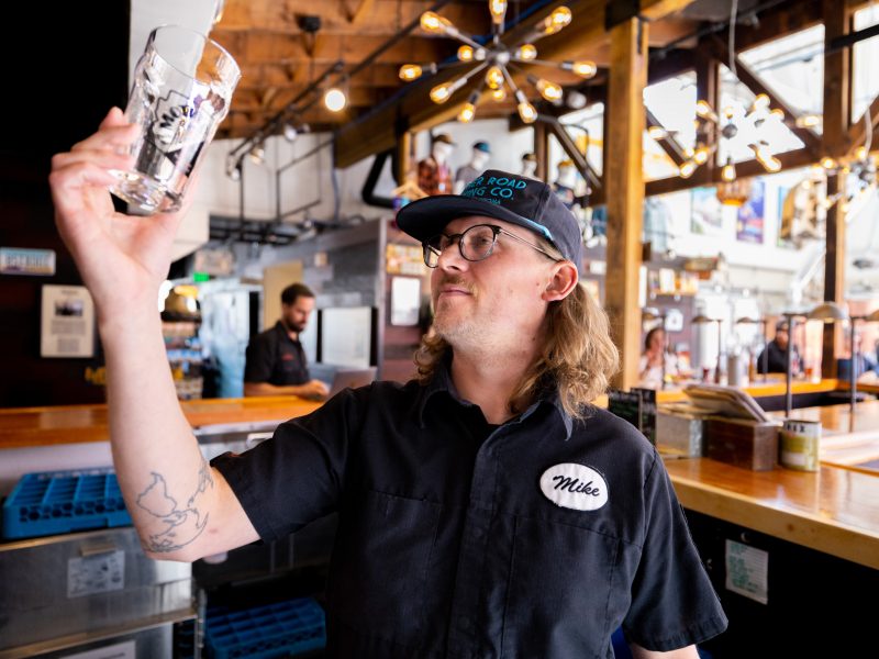 A man holding up a beer glass.