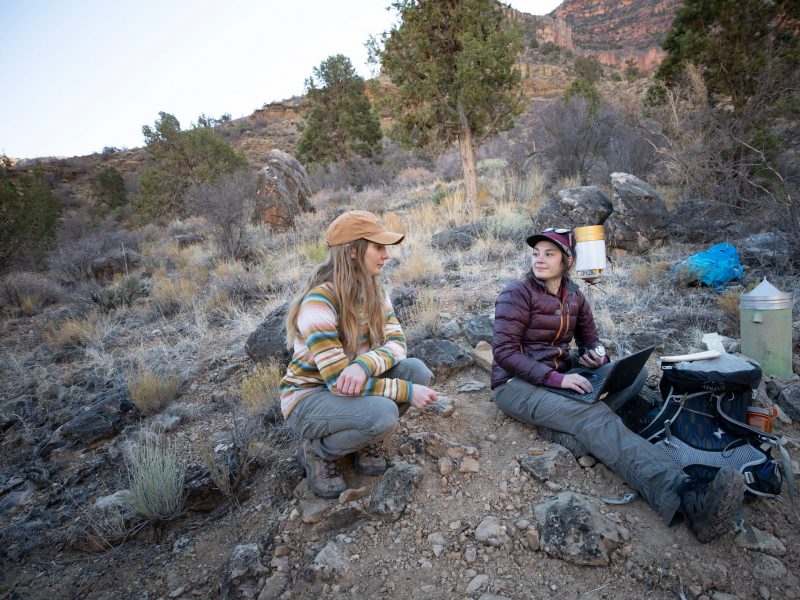 Two research students working on a project outside.