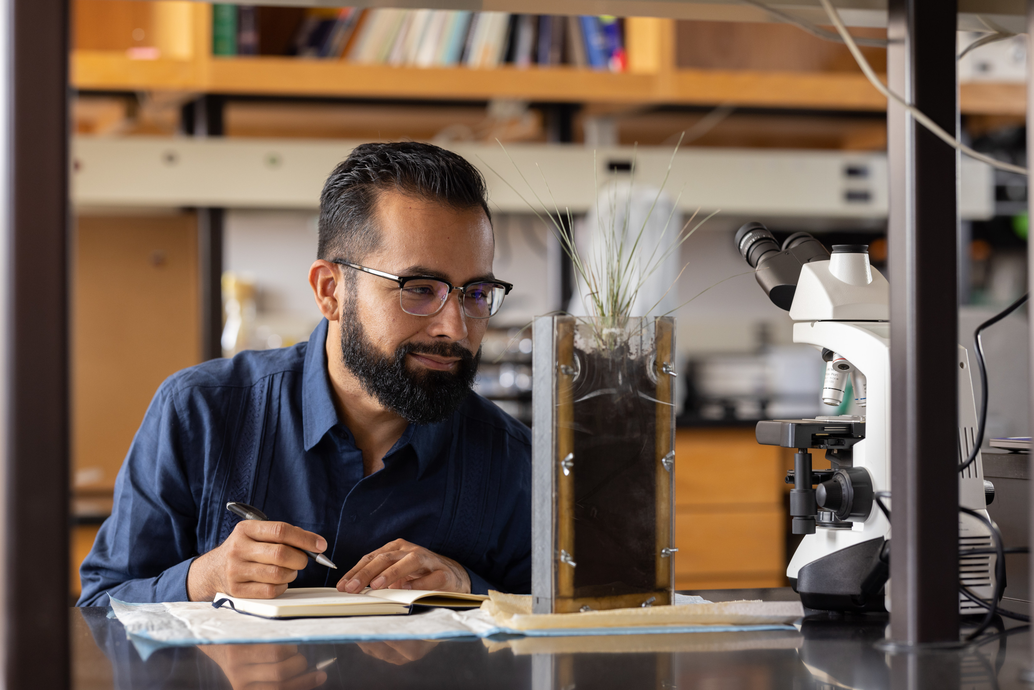 Javier navarro studying a soil sample.