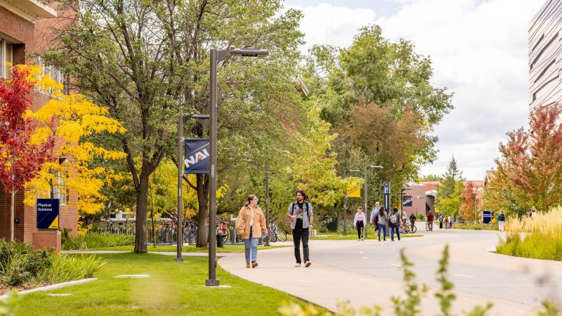 Two students walking on campus.