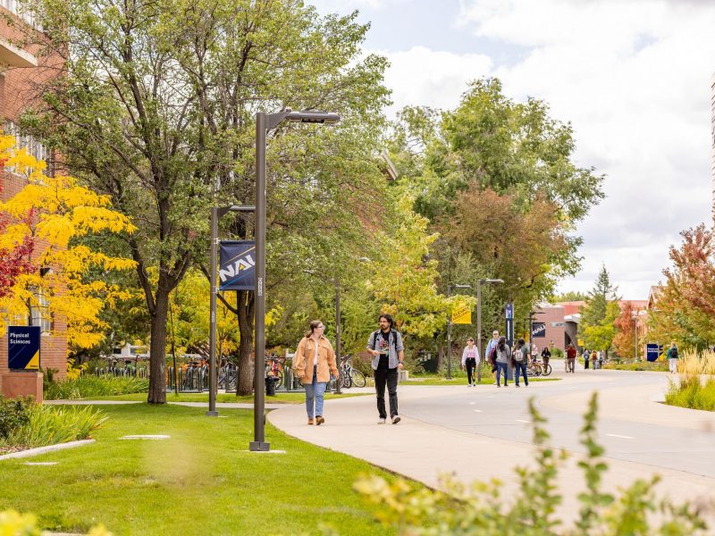 Two students walking on campus.