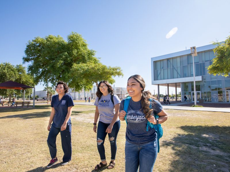 Three students walking outside at the statewide campus.