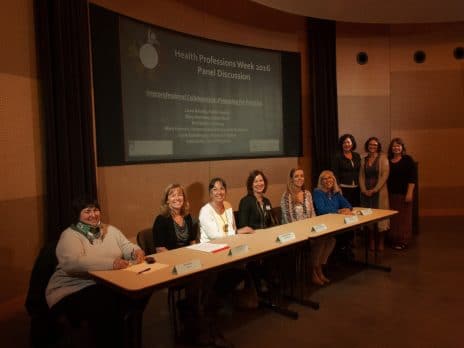 Faculty panelists and panel organizers in front of the auditorium at the Interprofessional Collaboration Panel