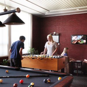 Picture of two people playing pool in McDonald game room