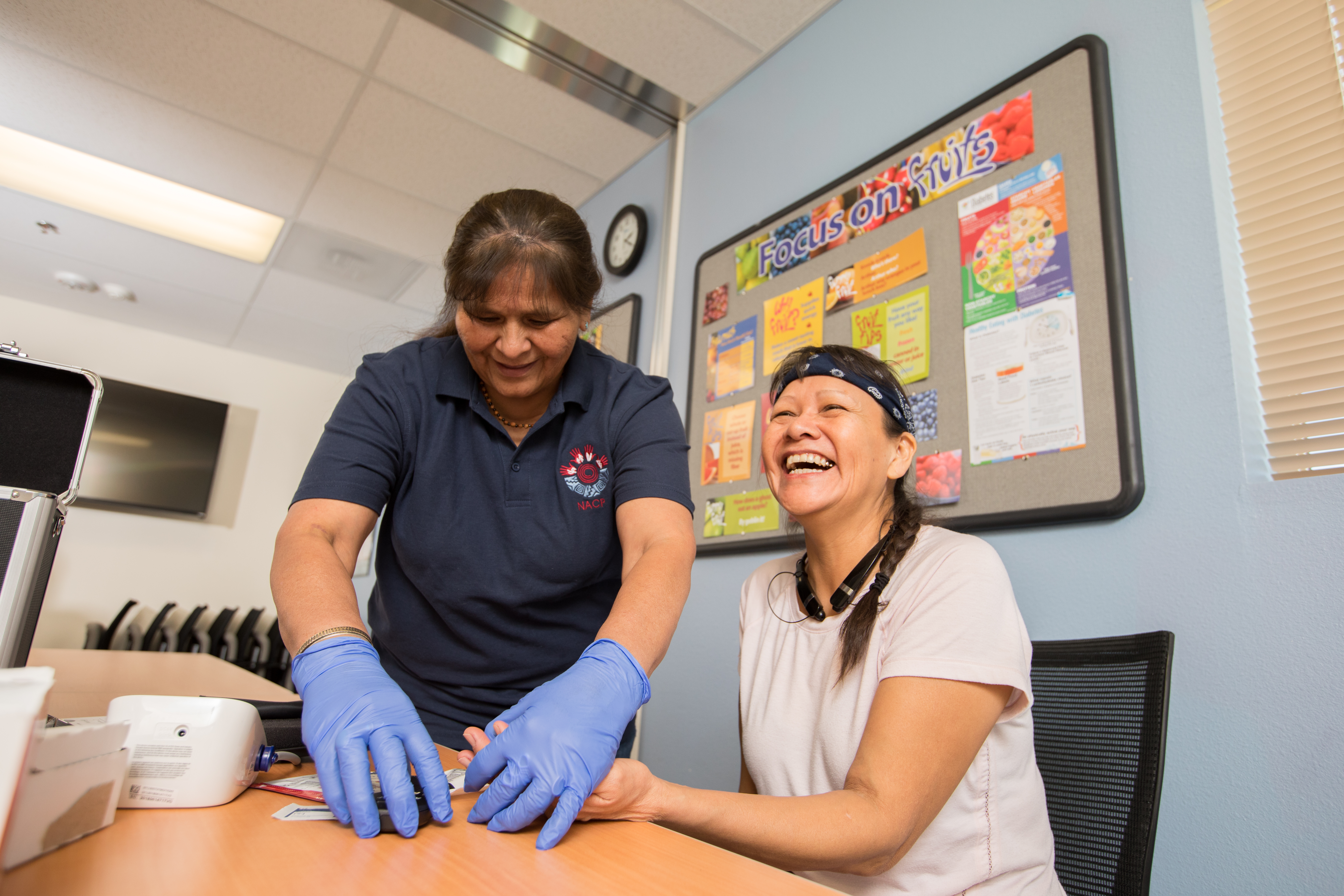 Students smiling while performing nurse practice.