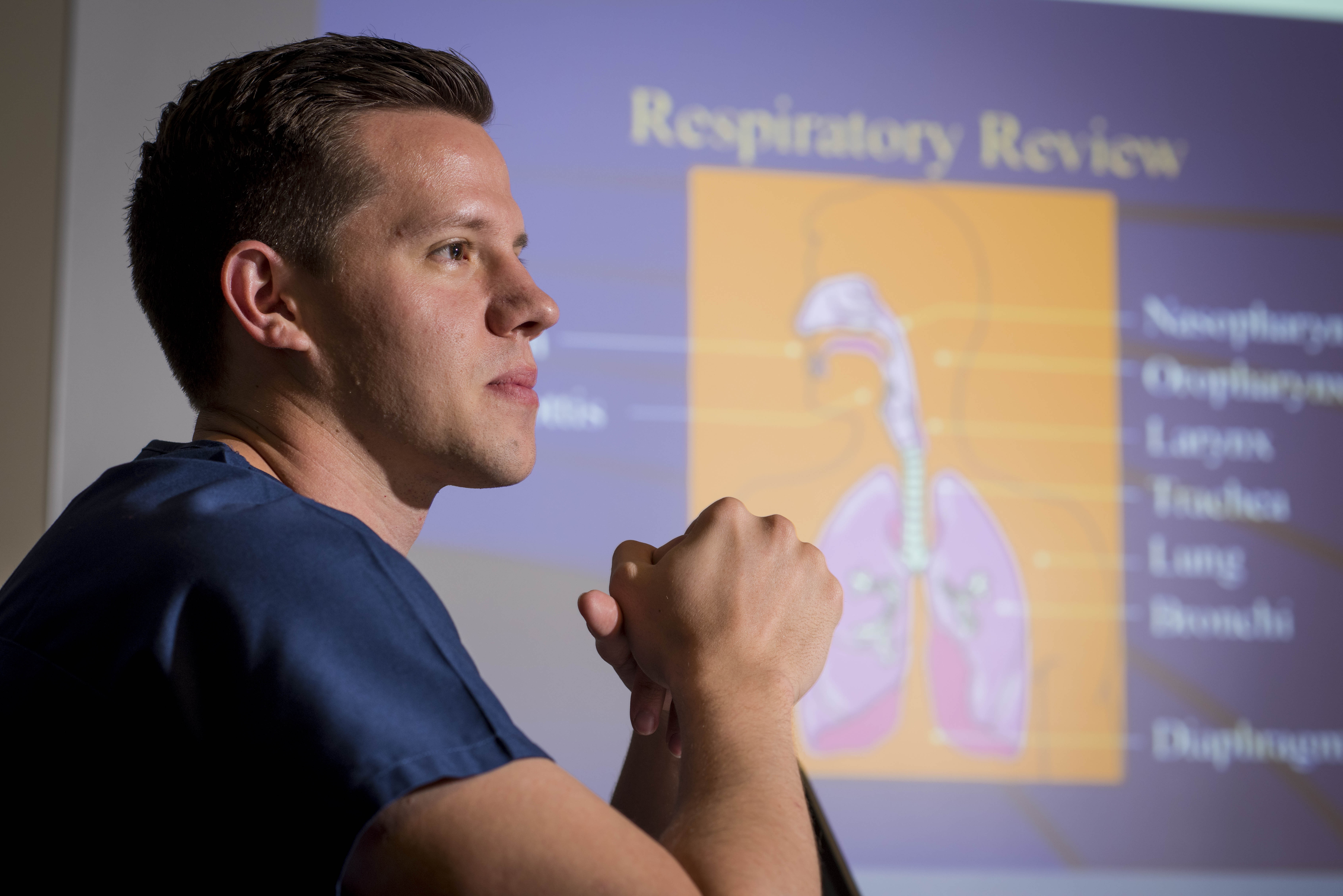 Male nursing student working on presentation.