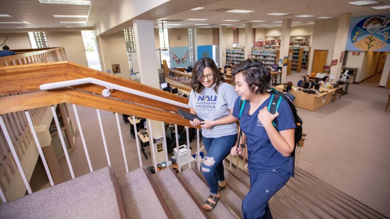 Undergraduate students in N A U's nursing program explore the library on the N A U Yuma campus.