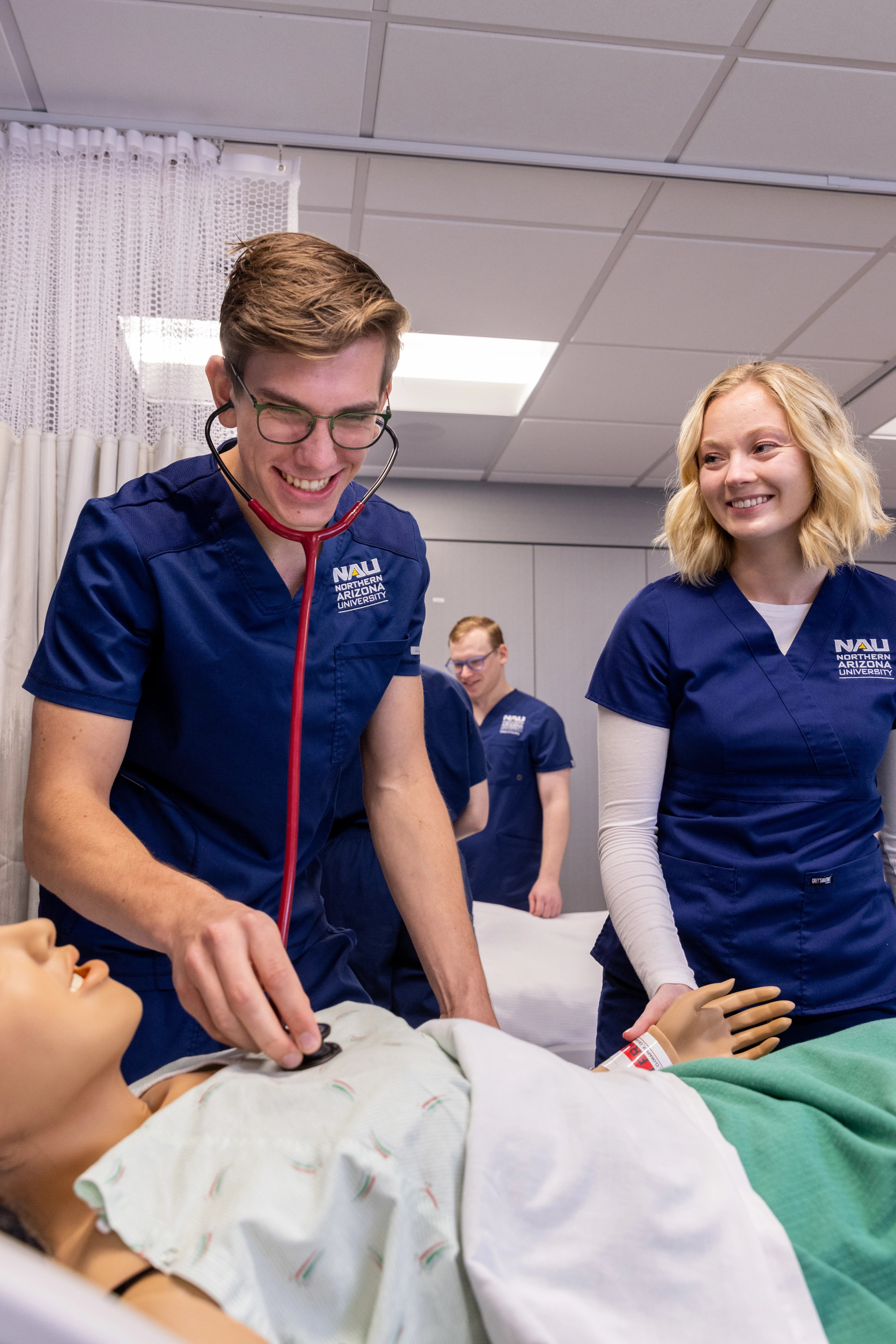 Nursing student working on patient.