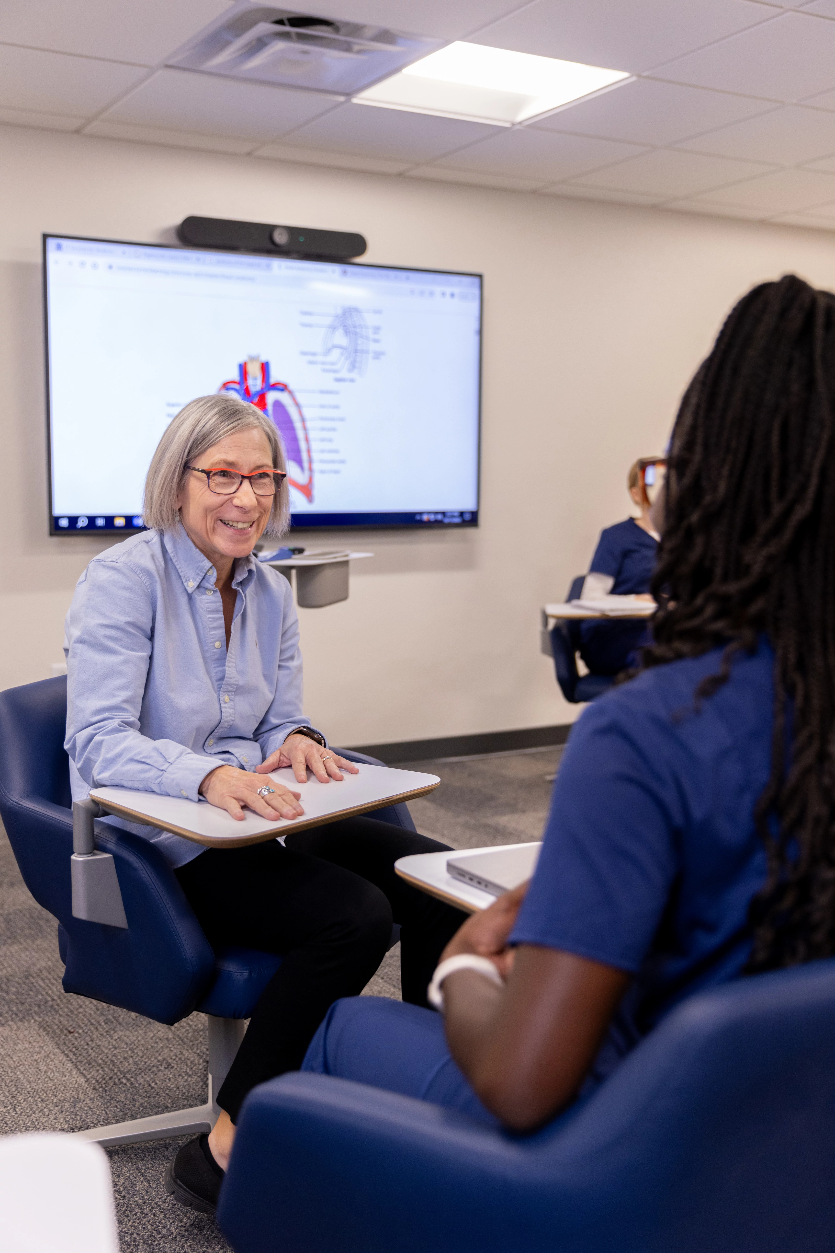 A professor in N A U's College of Nursing works one on one with students.