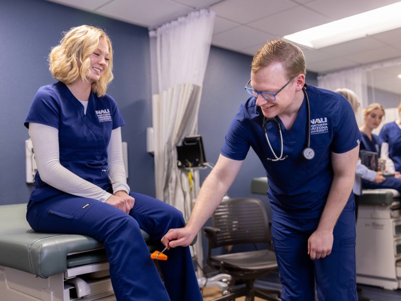 N A U Nursing students practice testing reflexes.