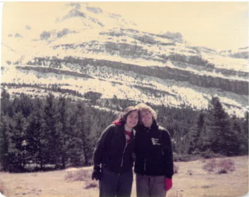 Sue and Sue in front of snowcapped mountains in the early 70s.