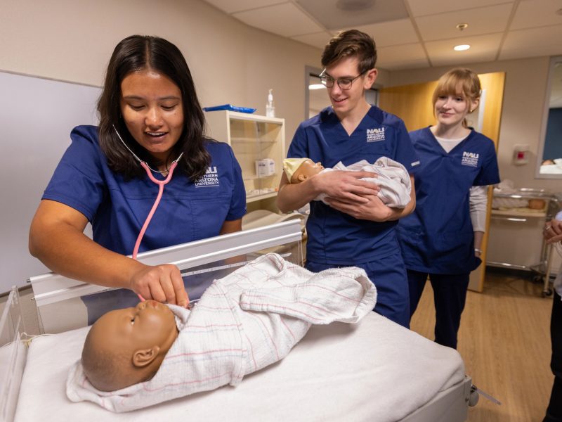 Students practice caring for babies in a N A U Nursing class.