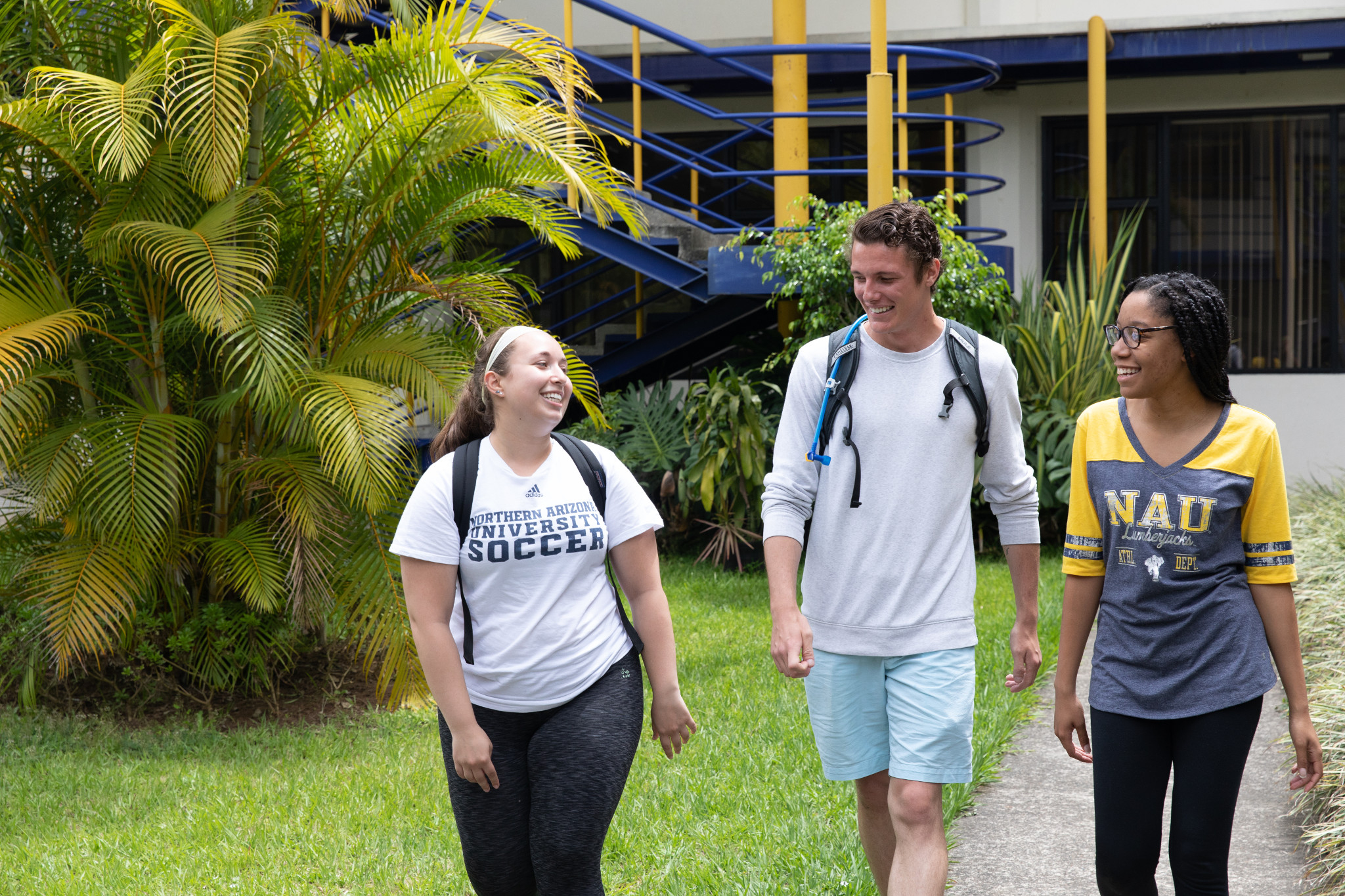 N A U students walking and laughing while studying abroad.