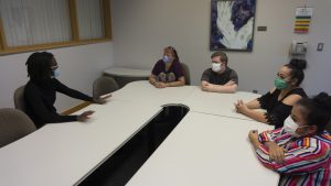 Students with their parents sit in a coaching session with masks