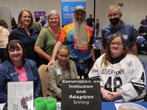 Flagstaff Mayor Becky Daggett at the Fair posing with members of the Commission on Inclusion and Adaptive Living