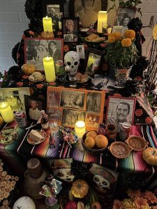 Dia de los Muertos altar with candles and pictures