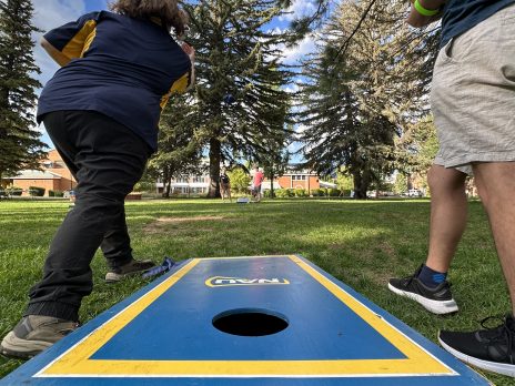 Mentor and Students Playing Cornhole