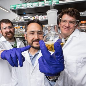 Robert Kellar, Nathan Nieto, Andy Koppisch stading in lab with their invention