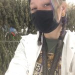 Victoria stands in front of cannabis at her new job