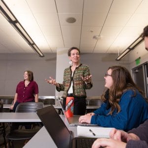 Professor lecturing students in a classroom.