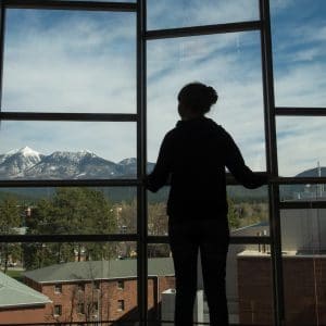 nau student looks toward the peaks from fifth floor