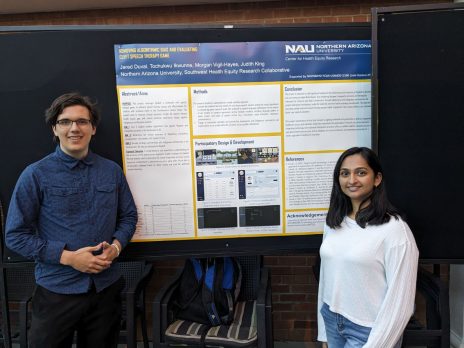 Chaithanya and Hunter stand by a poster describing how the team is removing algorithmic bias from SpokeIt, a telehealth cleft speech therapy game.