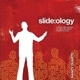 Book cover with a red background and a person's figure in white. Book is titled Slide-ology: The Art and Science of Creating Great Presentations.