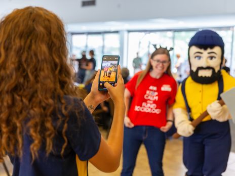 woman taking photo of louie the lumberjack and woman in red shirt