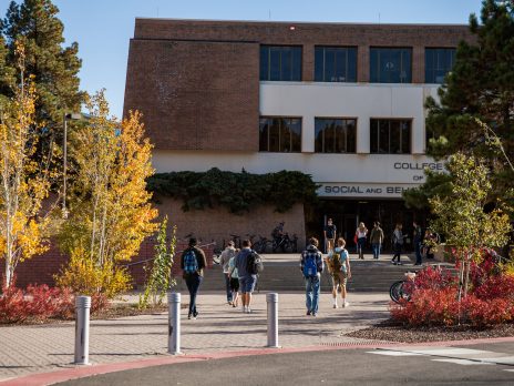 Students walking into the social and behavioral sciences building.