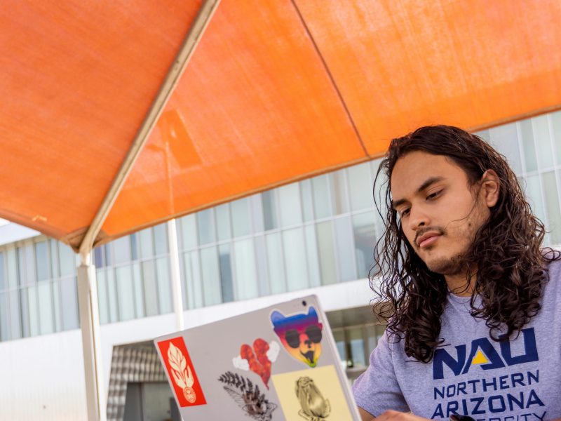 Student, Eduardo Moreno works outside at the NAU–Yuma campus