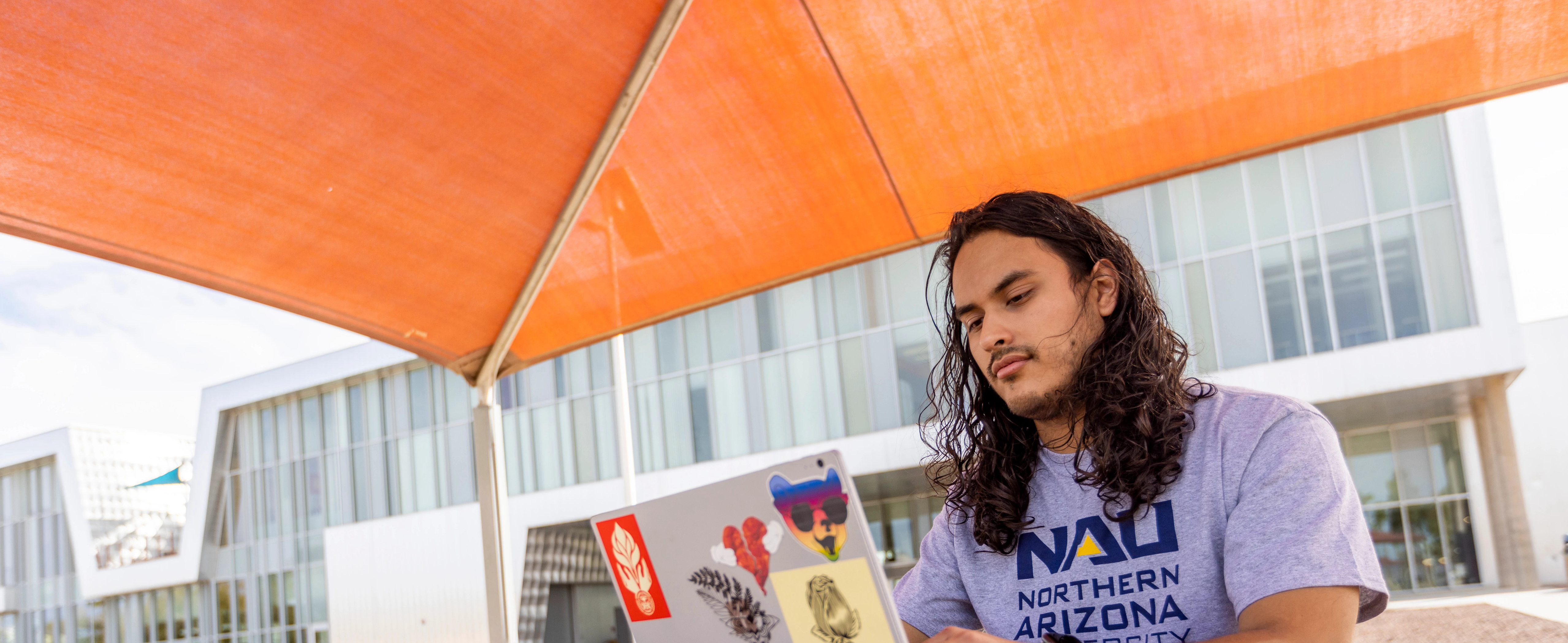 Student, Eduardo Moreno works outside at the NAU–Yuma campus