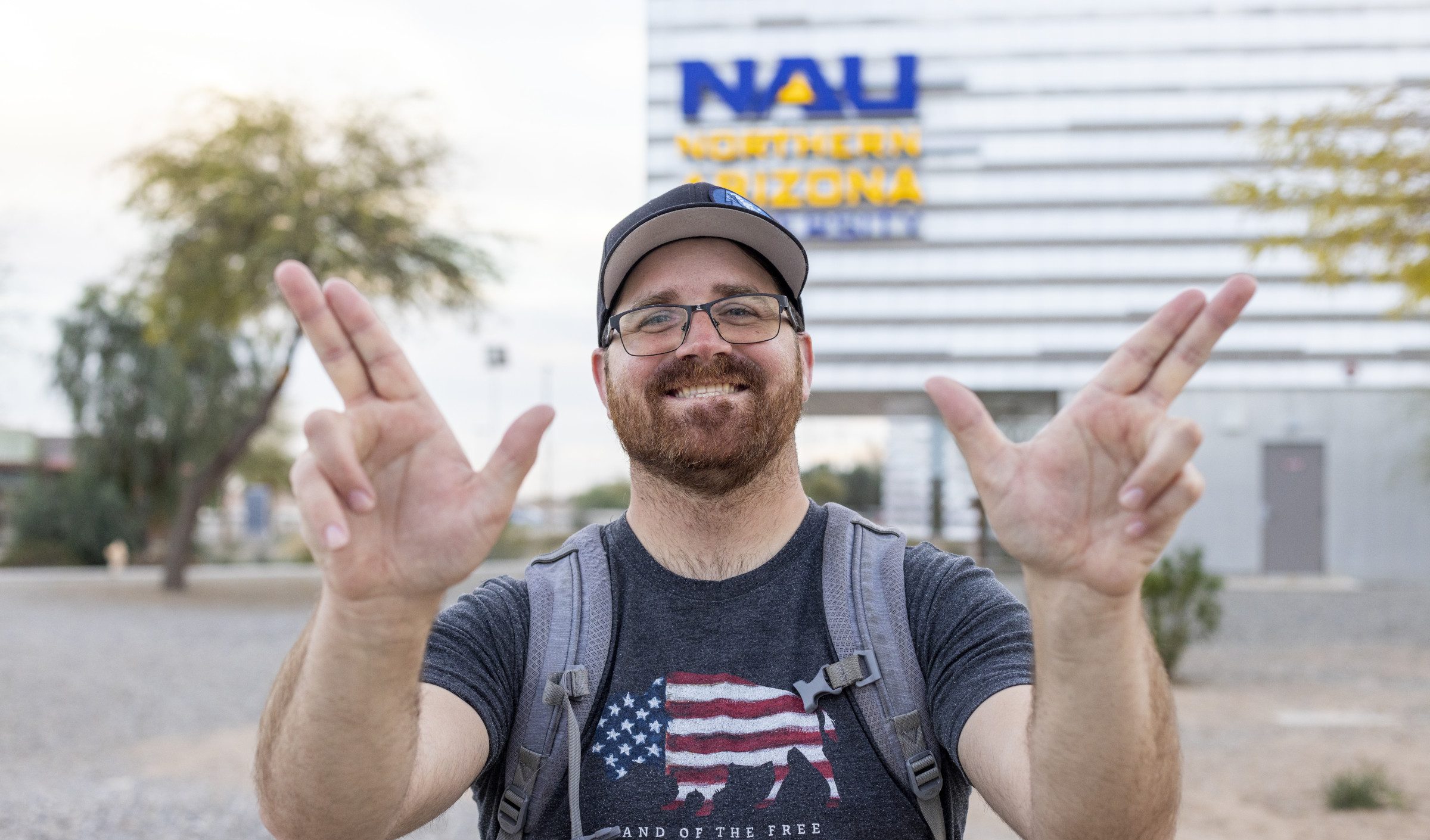 NAU–Yuma student holding up hands in jack symbol
