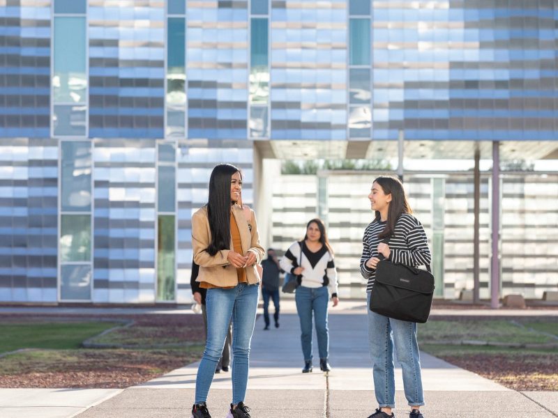 Students chatting outside of a building on the NAU–Yuma campus.