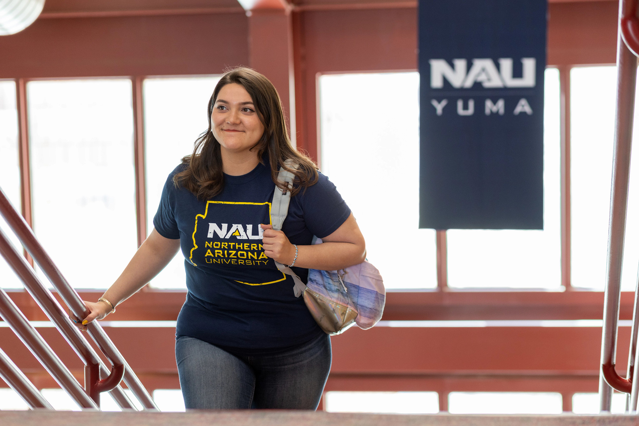 NAU–Yuma student walking up staircase