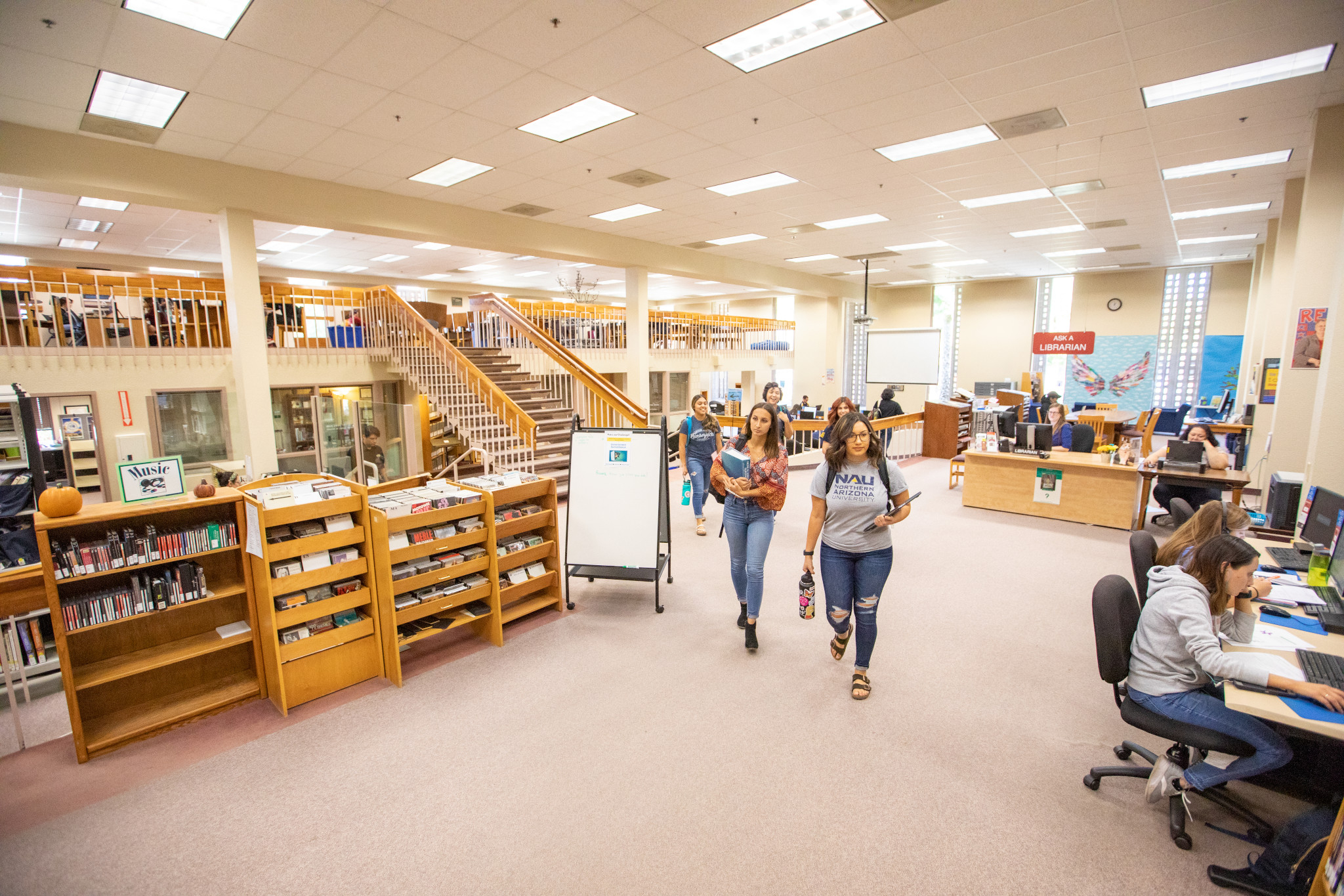 Students walking in the library at NAU–Yuma