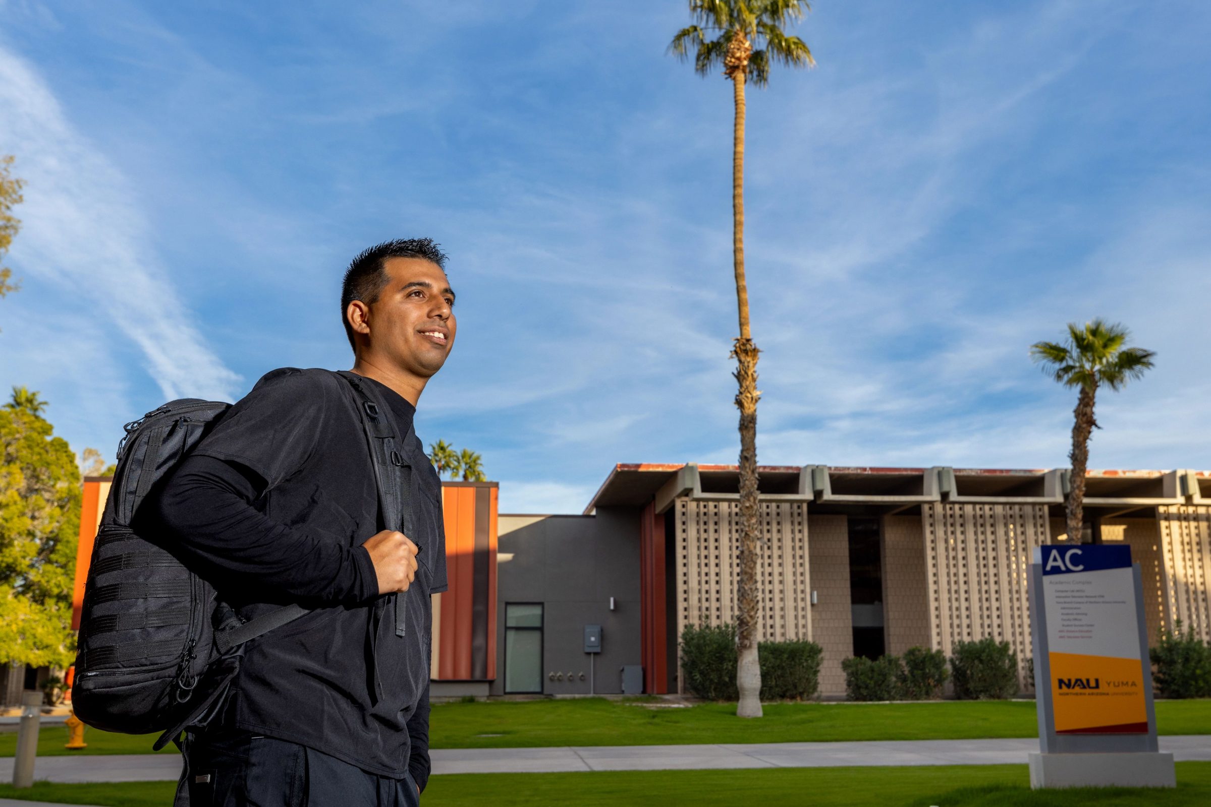 A student walks through the N A U Yuma campus