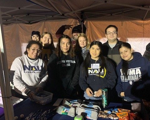 NAU-Yuma Social Work students and volunteers in front of the supplies they are donating.
